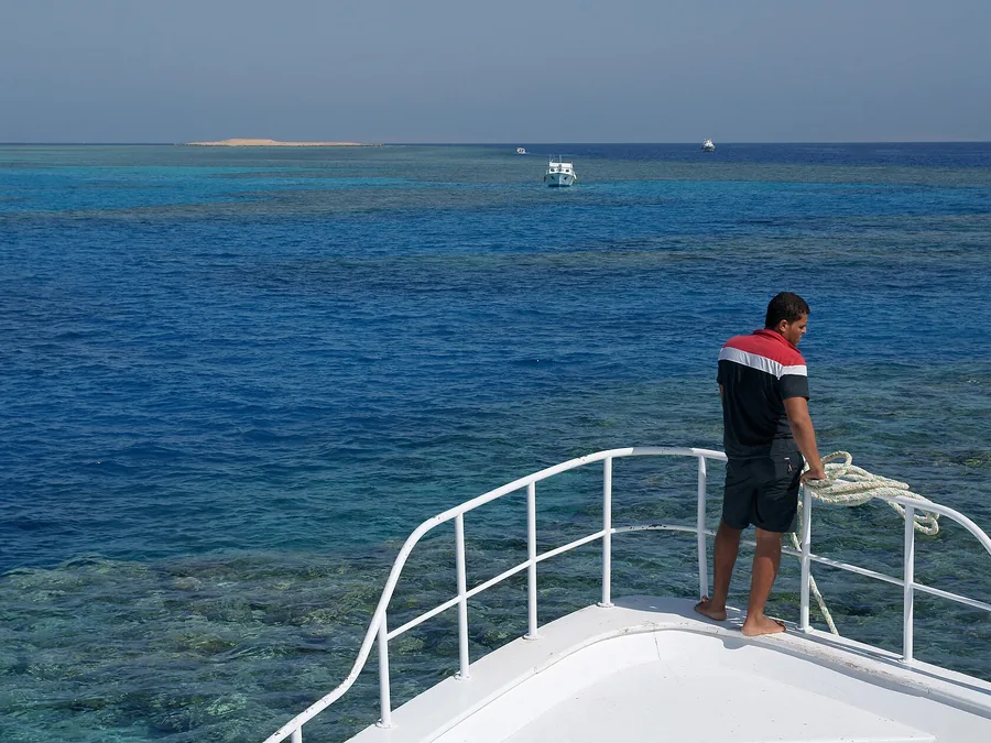 Snorkeller above a coral reef in the clear water of the Red Sea
